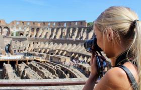 Girl taking photo in colosseum